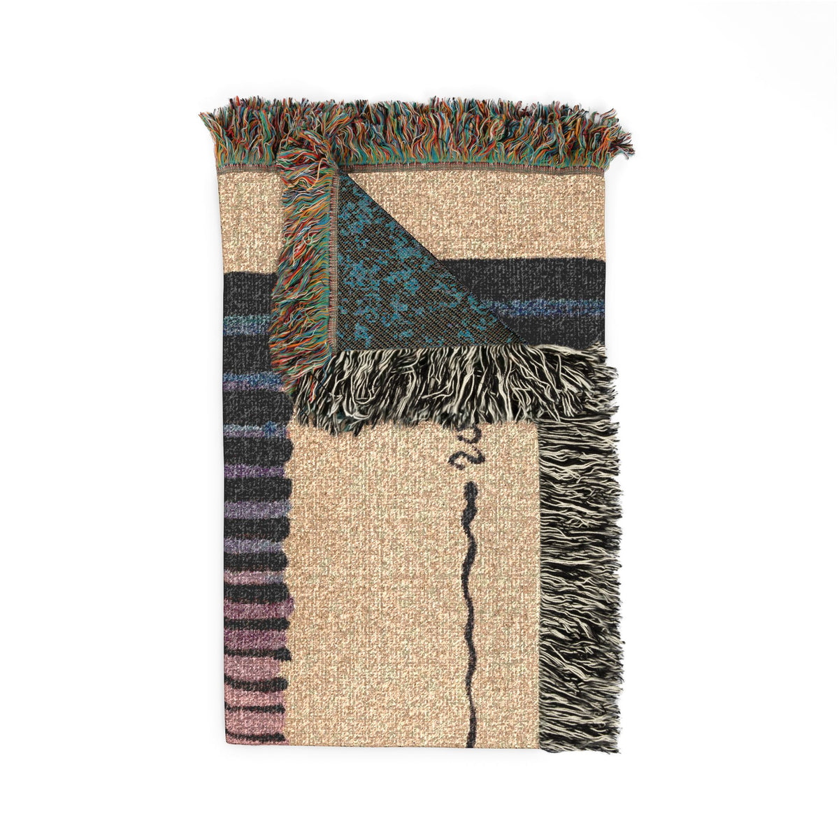 Sunset woven blanket folded, with one corner turned back to show the blue reverse side and fringe