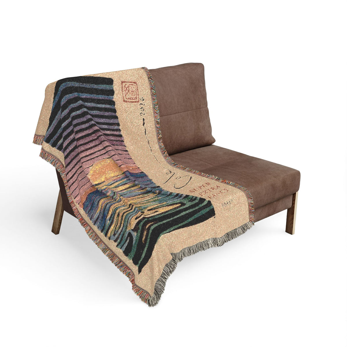 Sunset woven blanket draped over the seat and arm of a brown armchair