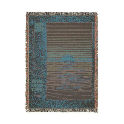 Reverse side of the woven blanket, where the weave shows the sunset drawing in inverted blue and brown tones